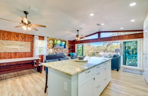 a kitchen and living room with a ceiling fan at Waterfront Home with Boat Dock and Slip in Old Town! in Old Town
