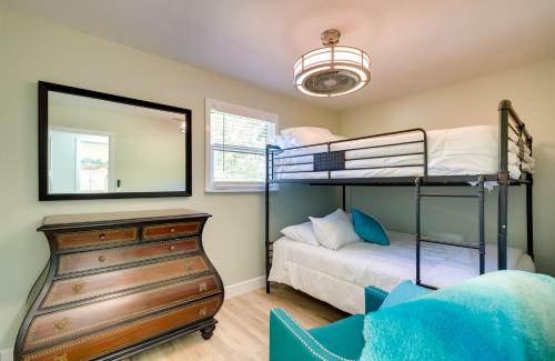 a bedroom with two bunk beds and a mirror at Waterfront Home with Boat Dock and Slip in Old Town! in Old Town