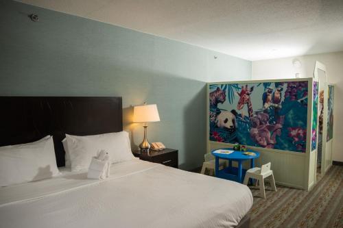 a bedroom with a bed and a painting on the wall at Wyndham Garden Erie in Erie