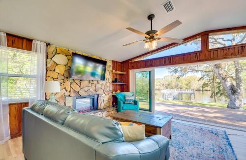 a living room with a couch and a stone wall at Waterfront Home with Boat Dock and Slip in Old Town! in Old Town
