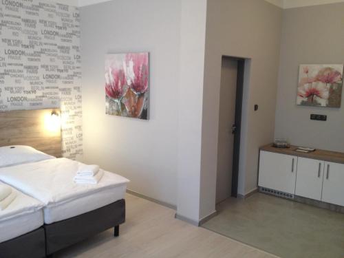 a room with a bed and a painting on the wall at Pension Phoenix in Znojmo