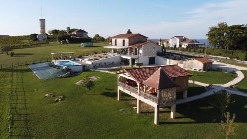 an aerial view of a house with a yard at Les cabanes de Monbazillac in Monbazillac