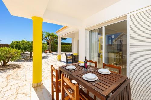 a wooden table on the patio of a house at Villa Brejos in Albufeira