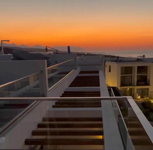 a stairway on top of a building at sunset at Retreat, Block A1, unit 6 in Küçükerenköy