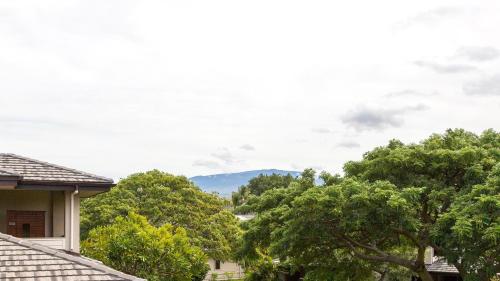 a view of trees and a mountain in the distance at Villages At Mauna Lani 621 in Waikoloa