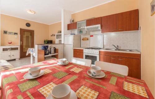 a kitchen with a table with chairs and a tablecloth on it at Holiday Home Kature Iv in Labin
