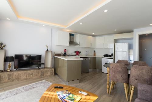 a kitchen and living room with a table and appliances at Elegance Penthouse by HolidayKeys in Temblos