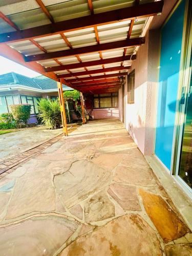 an outdoor patio with awning on a house at Executive Accommodation Bellville 2 in Cape Town