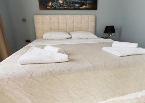 a large bed with two white towels on it at Elegance Penthouse by HolidayKeys in Temblos