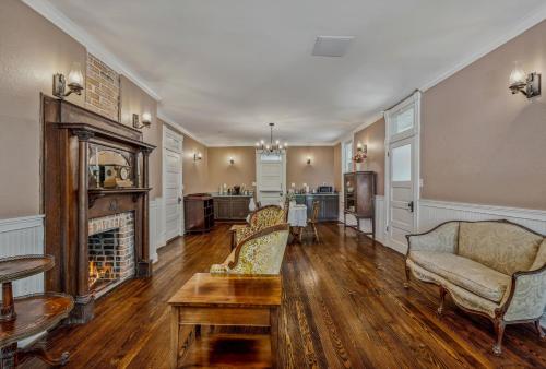 a living room with a couch and a fireplace at The Grand Castalian Inn Bed and Breakfast in Berkeley Springs