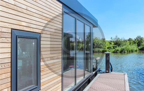 a house on the water with a dock at Gorgeous Ship In Ohé & Laak With Wifi in Ohé en Laak
