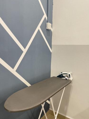 a skateboard sitting on a stand next to a wall at Cozy Roomstay Teluk Intan in Teluk Intan