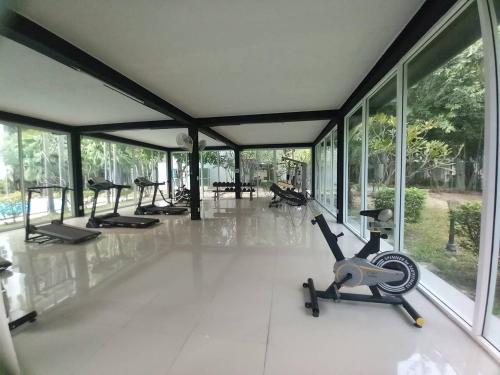 a gym with several treadmills and elliptical machines at AD resort ชะอำ in Ban Bo Khaem