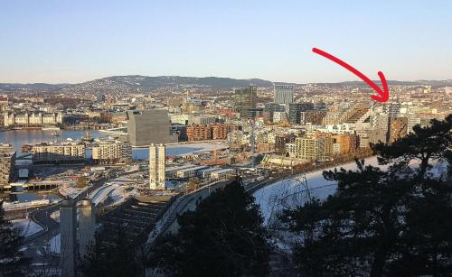 a view of a city with a red arrow at Super Central Designer Penthouse at 19th floor with Amazing View! in Oslo
