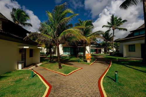 Ein Garten an der Unterkunft Bangalô - Beach Class Resort - Praia Muro Alto - Porto de Galinhas - by HomeTemp
