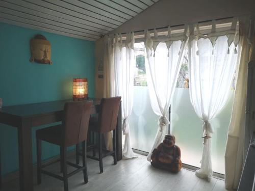a small child sitting on the floor in front of a window at La Balinaise in Saint-Jean-de-Védas