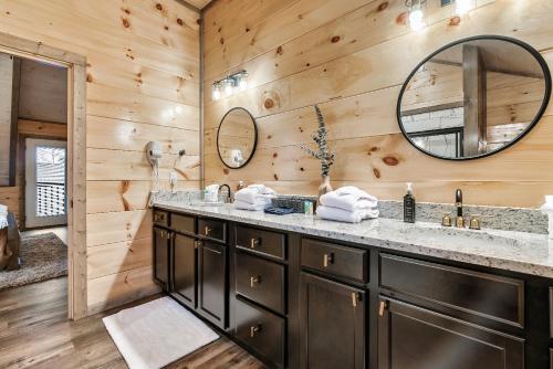 a bathroom with a sink and a mirror at Near Dollywood With Hot Tub, Game Room Home Theater in Sevierville