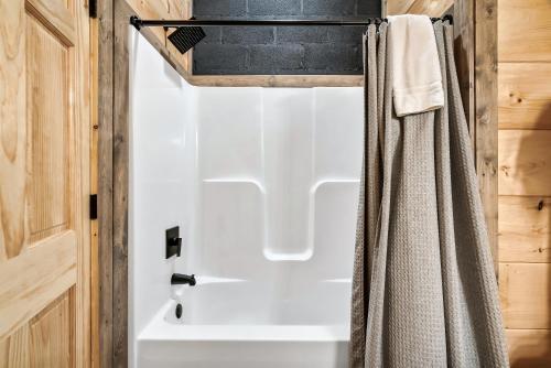a bathroom with a shower and a white tub at Near Dollywood With Hot Tub, Game Room Home Theater in Sevierville