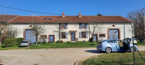 a car is parked in front of a house at Gîte La Cour Cachée in Saulx-en-Woëvre
