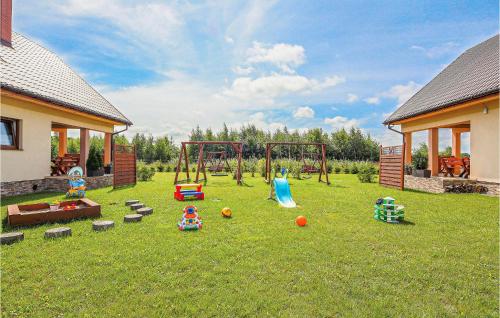 a playground in a yard with toys on the grass at 3 Bedroom Beautiful Home In Mscicie in Podamirowo