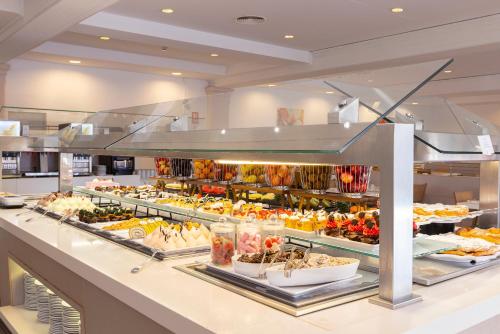 a buffet line with many different types of food at Hipotels Mediterraneo Club in Sa Coma