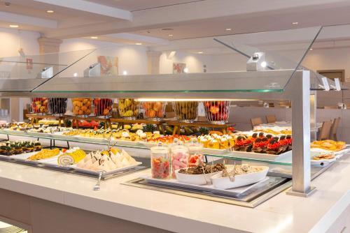 a buffet line with many different types of food at Hipotels Mediterraneo Club in Sa Coma