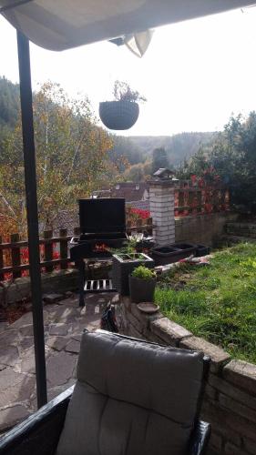 a living room with a couch and a piano on a patio at Nižbor samostatný domek v zahradě in Nižbor