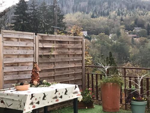 a table on a balcony with a fence at Gîte Monts et Merveilles in Mollau