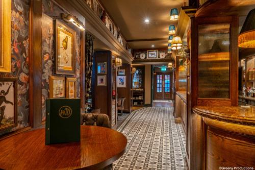 a bar with a wooden table in a pub at The Bull Hotel; Sure Hotel Collection by Best Western in Peterborough