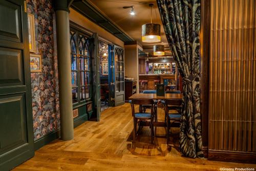 a dining room with a table and chairs at The Bull Hotel; Sure Hotel Collection by Best Western in Peterborough