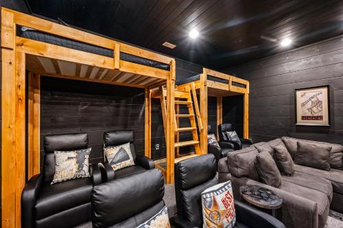a living room with a couch and a bunk bed at Near Dollywood With Hot Tub, Game Room Home Theater in Sevierville