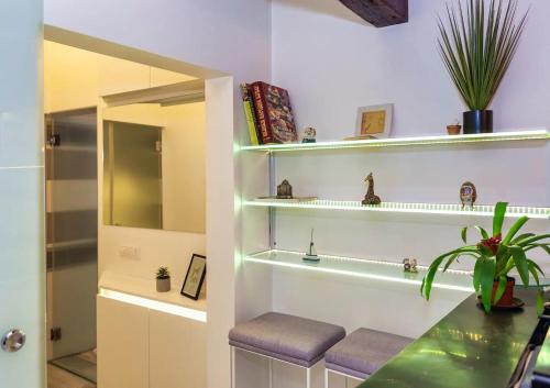 a bathroom with white walls and shelves and a counter at City Centre Rooftop Knez Mihailova Apartment in Belgrade