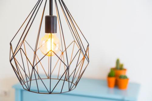 a metal light fixture hanging over a blue table at Bij Jans in Hilvarenbeek