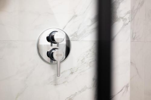 a shower door with a key in it at Visconti Suites - Luca Stay in Milan