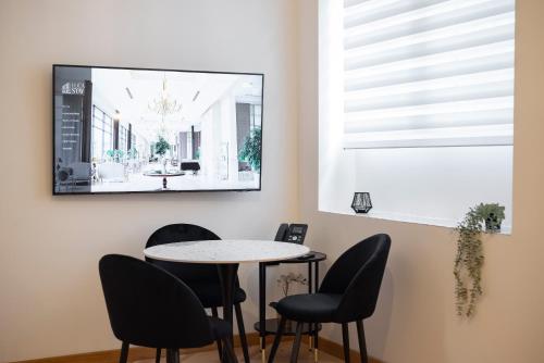 a dining room with a table and chairs at Visconti Suites - Luca Stay in Milan
