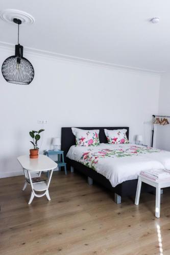 a bedroom with a bed and a table at Bij Jans in Hilvarenbeek