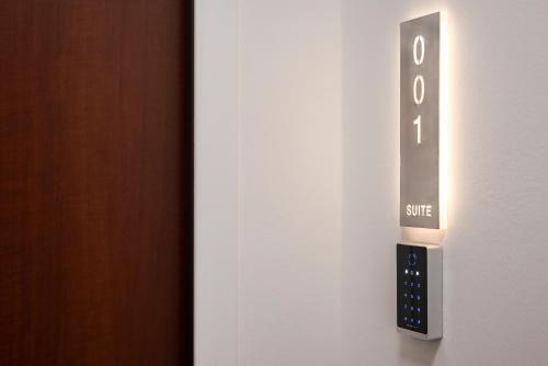 a close up of a door with an exit sign at Visconti Suites - Luca Stay in Milan
