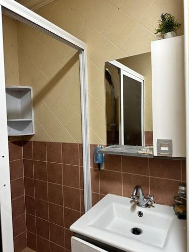 a bathroom with a sink and a mirror at Tradition & Tranquility in Tamraght Ouzdar