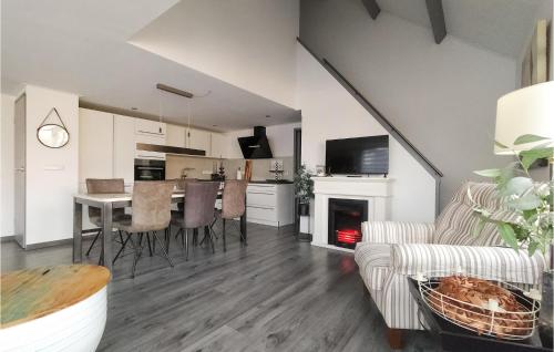 a living room with a table and a fireplace at 3 Bedroom Awesome Home In Stavenisse in Stavenisse