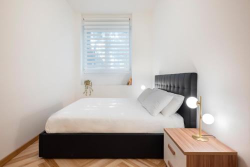 a bedroom with a bed and a window at Visconti Suites - Luca Stay in Milan