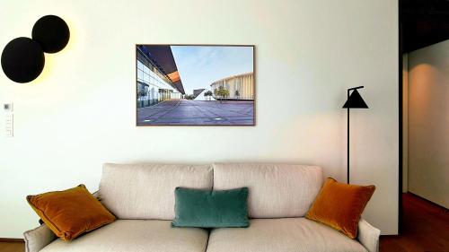 a living room with a couch and a picture on the wall at The Central City - Luxury Serviced Residence in Luxembourg