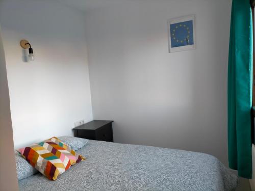 a bedroom with a bed with a pillow on it at Apartamento rural con vistas in Miraflores de la Sierra
