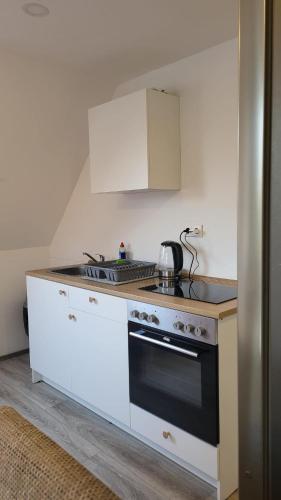 a kitchen with a stove and a counter top at Apartment Home in NRW in Gladbeck