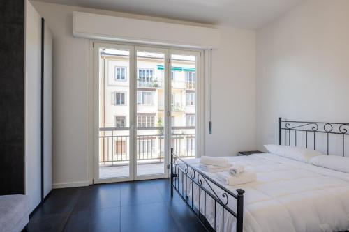 a bedroom with a bed and a large window at Lungarno Apartment in Florence