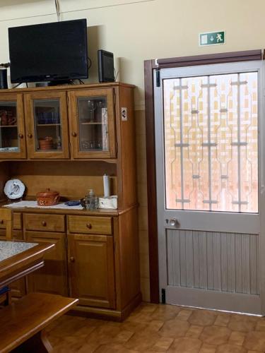 a kitchen with a large window and a door at Quinta da Capela in Celorico de Basto