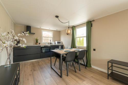 a kitchen with a table and chairs in a room at 49, Efteling - Beekse Bergen - Dog Friendly in Oisterwijk