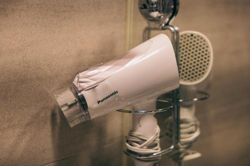 a blow dryer is hanging on a wall at 新龍頭古厝行館 Shin Long Tou B&B in Jinning