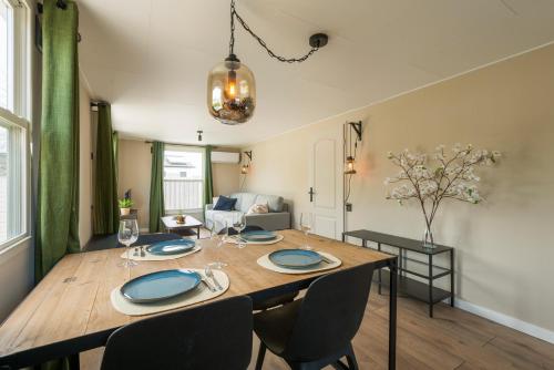 a dining room and living room with a table and chairs at 49, Efteling - Beekse Bergen - Dog Friendly in Oisterwijk