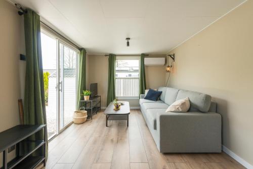 a living room with a couch and a table at 49, Efteling - Beekse Bergen - Dog Friendly in Oisterwijk