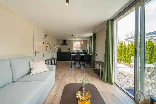 a living room with a couch and a table at 49, Efteling - Beekse Bergen - Dog Friendly in Oisterwijk